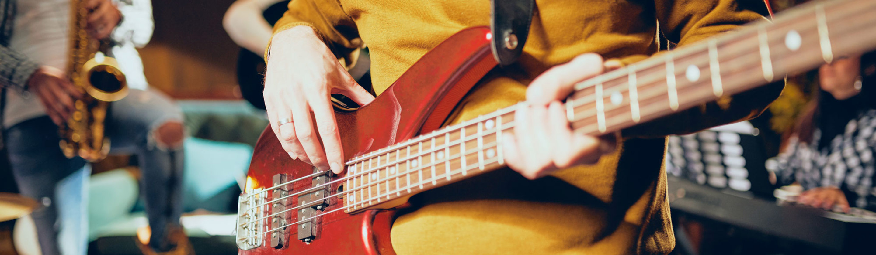A person strumming an electric guitar
