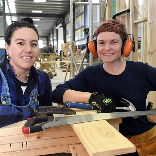 Two female carpentary students in Melbourne Polytechnic training warehouse
