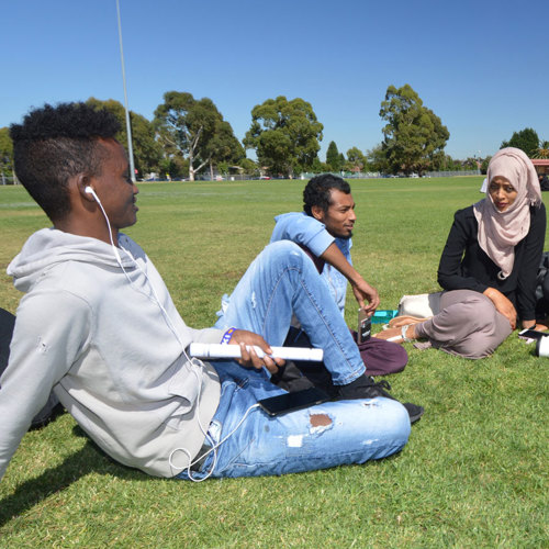 3 Students on lawn at Melbourne Polytechnic campus