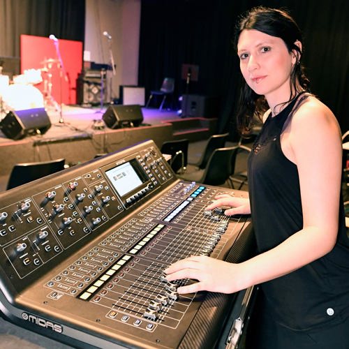Person standing at a live mixing desk