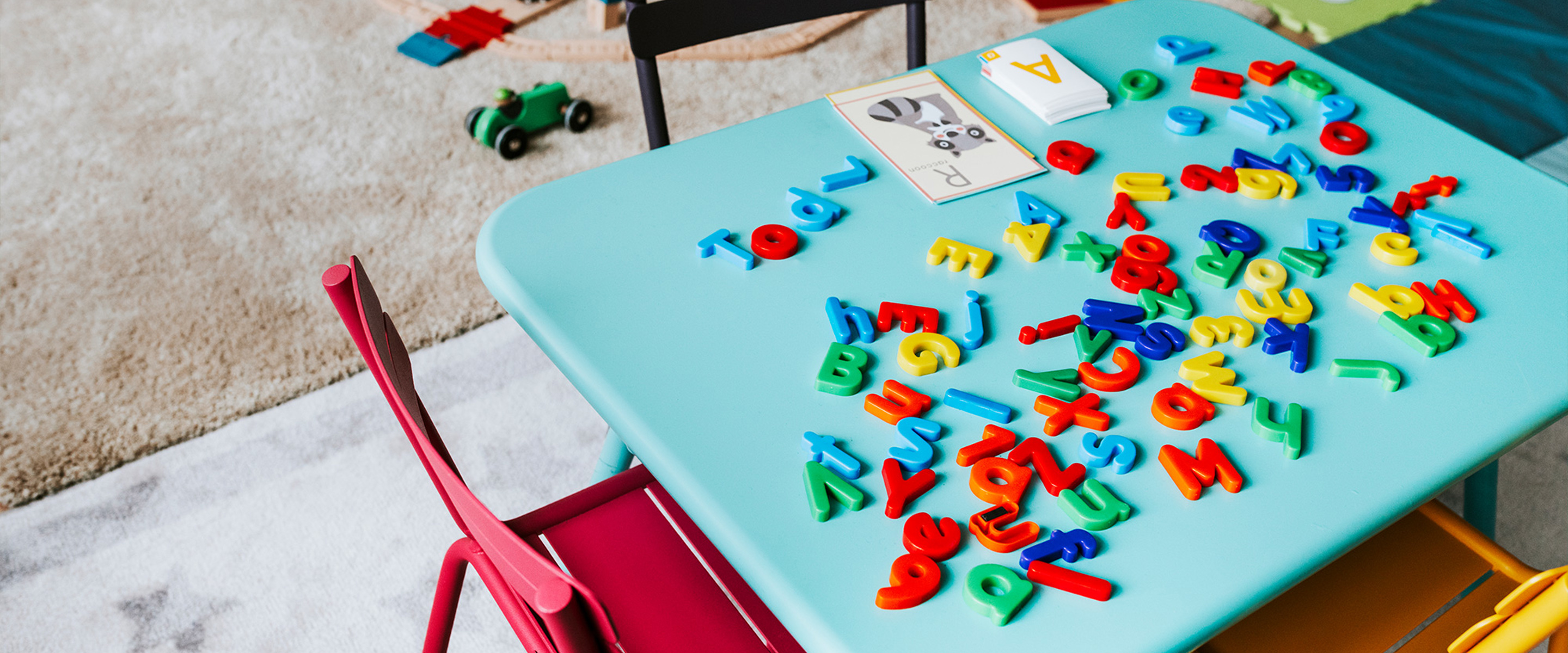 A blue children's table with educational toys in a childcare setting