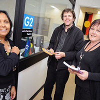 koorie services centre. three people smiling at camera