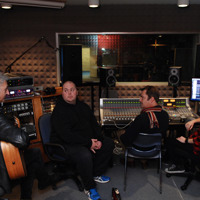 Musician sitting with producers and having a conversation