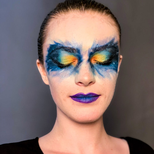Makeup model with blue to orange gradient on eyes (resembles interstellar nebula)