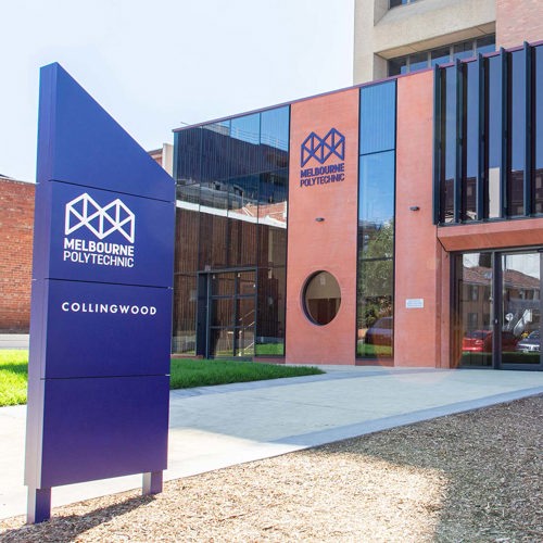 The Collingwood Campus entrance, displaying a blue sign that states "Melbourne Polytechnic."