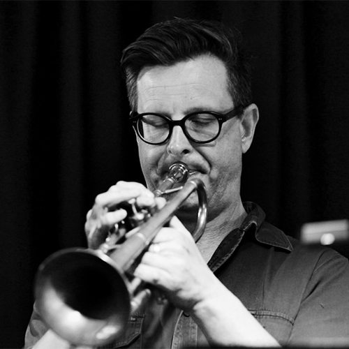 Black and white image of Eugene Ball playing the trumpet