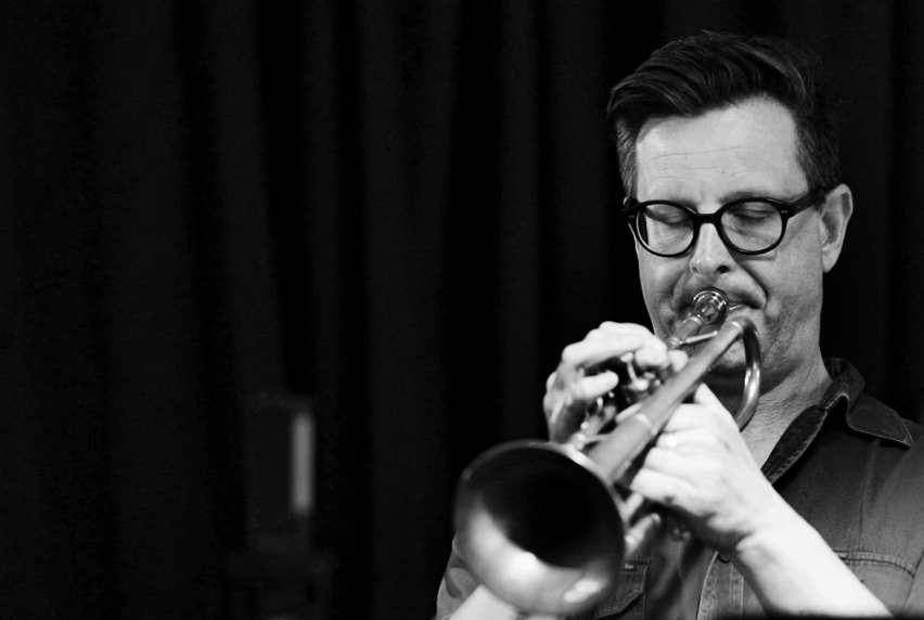 Black and white image of Eugene Ball playing the trumpet