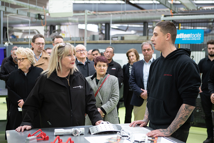 The Minister for Training and Skills and the Minister for Higher Education, the Hon Gayle Tierney MP speaks to a student at Melbourne Polytechnic's Advanced Manufacturing Centre of Excellence as people watch on in the background