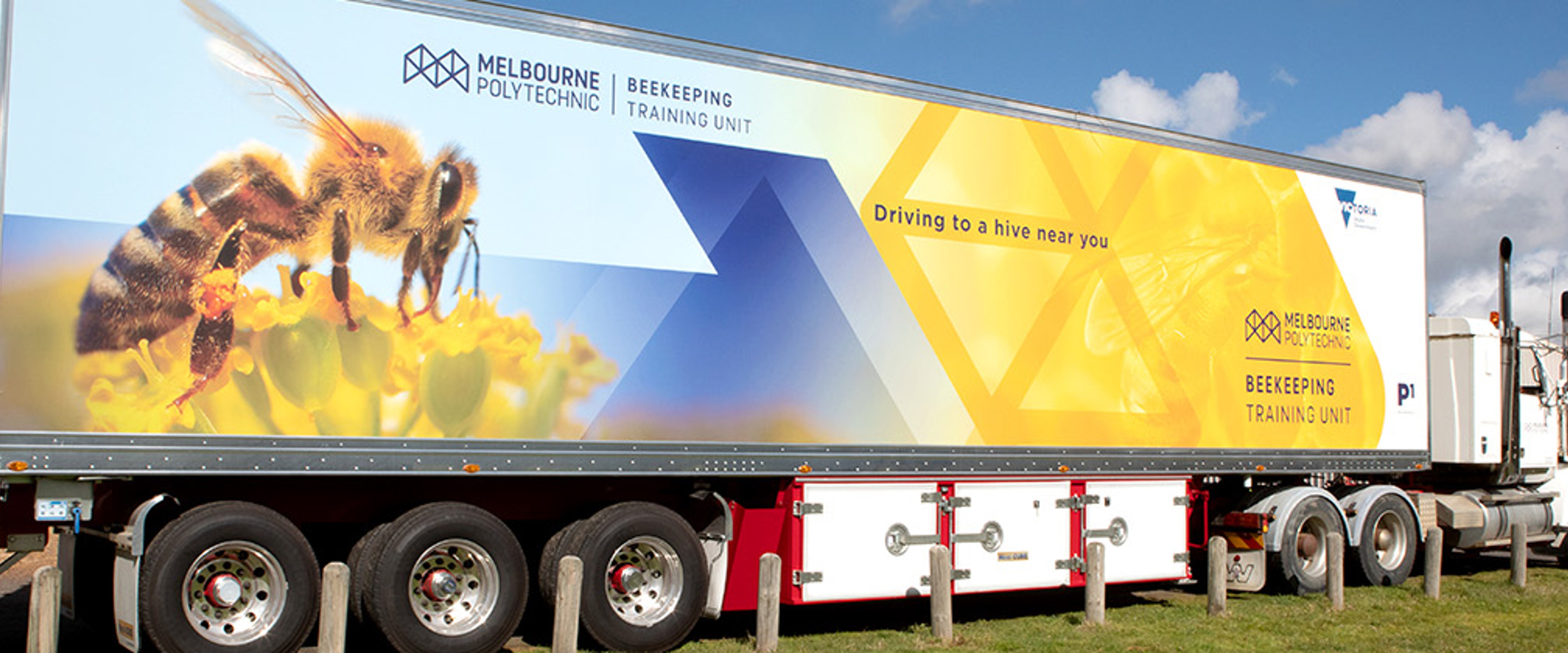 A large truck with "Melbourne Polytechnic Beekeeping Training Unit" and an image of a bee printed on the side.