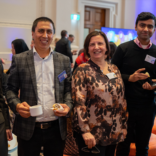 Five attendees, including Melbourne Polytechnic CEO, Frances Coppolillo, smile at the camera at the AMEP 75-year anniversary event